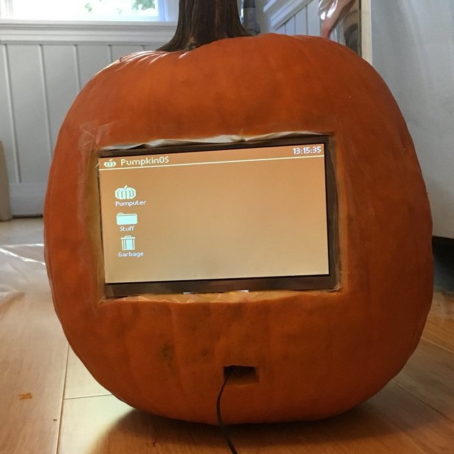 a computer screen embedded in a pumpkin